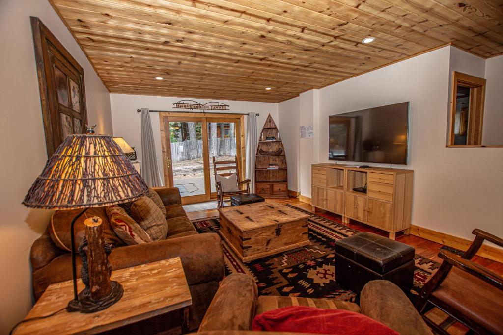 a living room with a couch and a table at Bonanza By Hauserman Rentals in Tahoe City