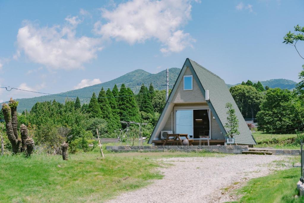 a small house in the middle of a field at 自然満喫 野上平ロッジ in Kirishima