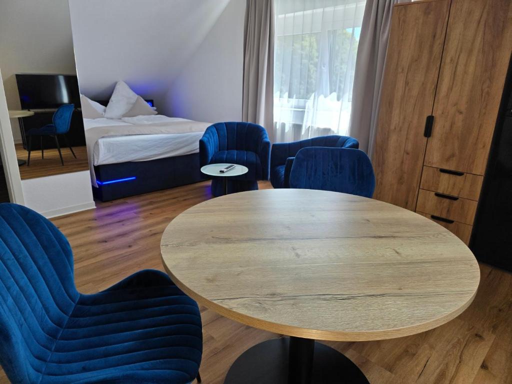 a room with a table and chairs and a bed at Modern apartment in downtown in Schwäbisch Hall