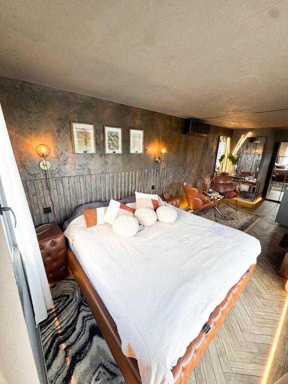 a bedroom with a large bed with white sheets and pillows at Retrīts MIGLA with sauna included in Stacija )) (( Blukas