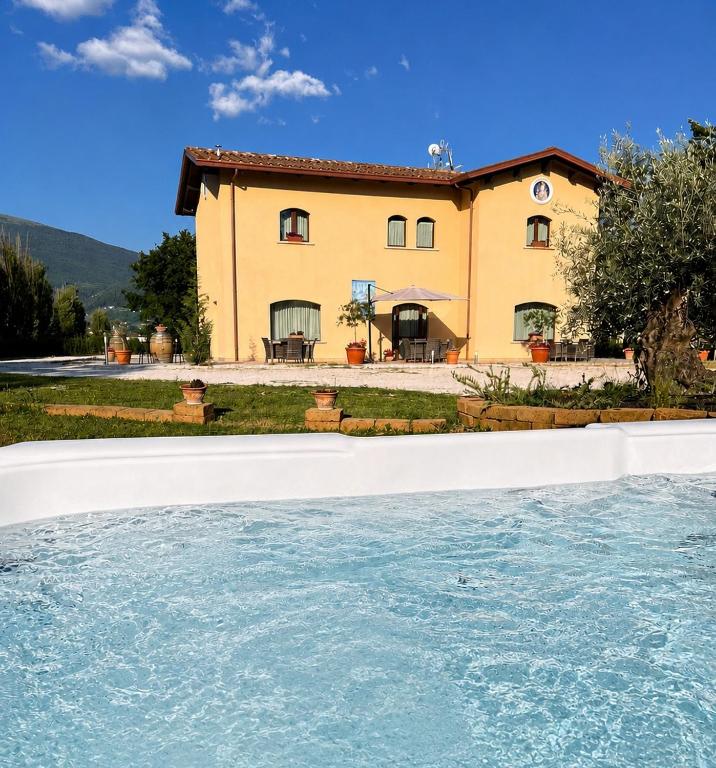 a house with a pool in front of it at Il Castellaccio in Spello