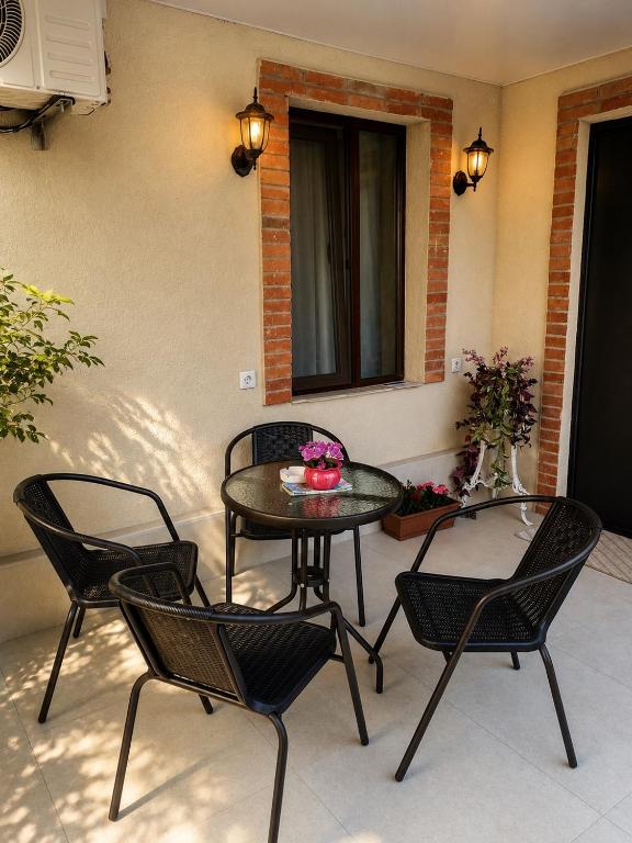 a patio with two chairs and a table and a table at garden and panorama in Mtskheta