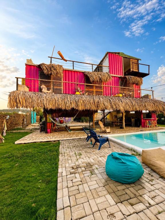 a building with a swimming pool and a resort at Mojarra Beach Casa Privada-Santa Veronica in Salina de Rey