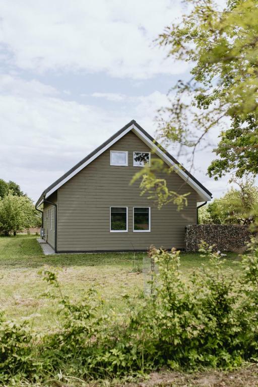 a house in a field with a yard at Obsenieki - moderna lauku sēta in Stalidzāni