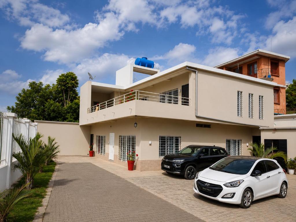 a white car parked in front of a house at Milestone Villa in Antananarivo