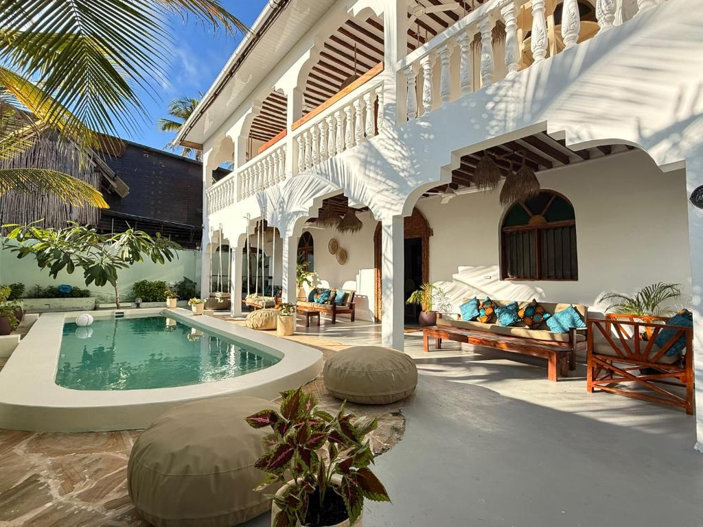 a villa with a swimming pool in a yard at Bahari Paje Beach House in Paje