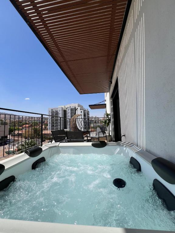 a hot tub on the balcony of a building at Cohav Sea View in Eilat