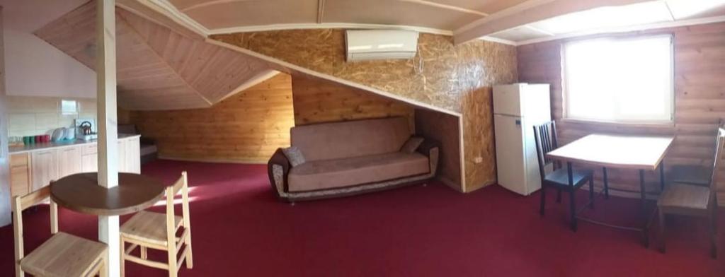 a room with a couch and a table and a kitchen at Апартаменти Аліканте in Zatoka