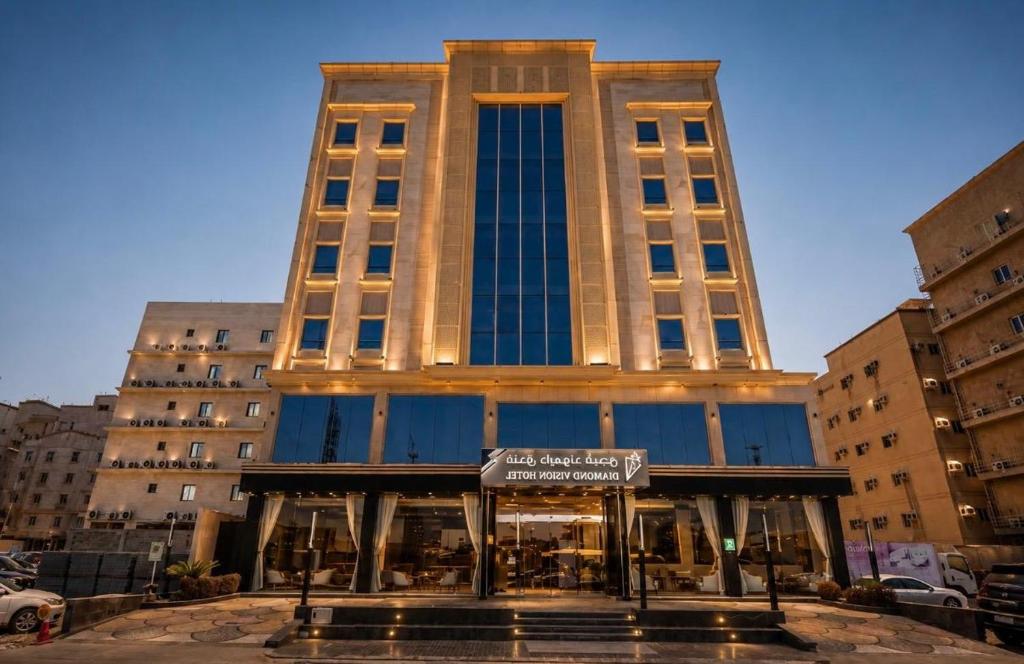 a tall building with a sign in front of it at Diamond Vision Hotel in Jeddah