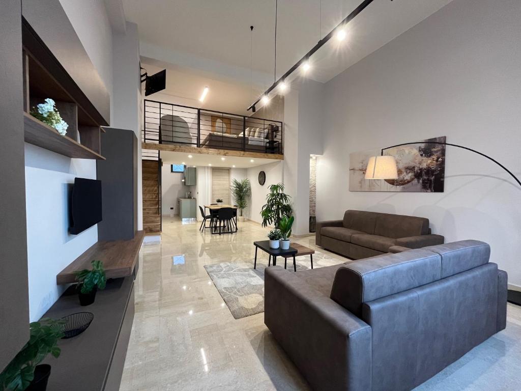 a living room with a couch and a table at Loft43 in Trani