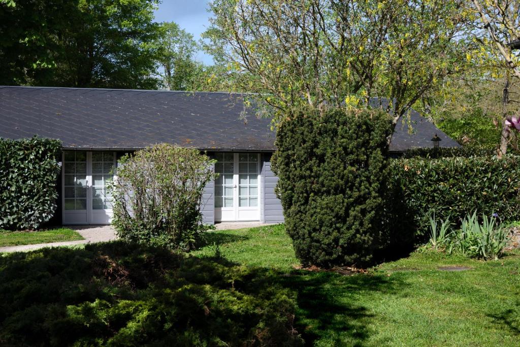a small white house with a roof at Gites de Coulonge in Coulonges-Ardennes