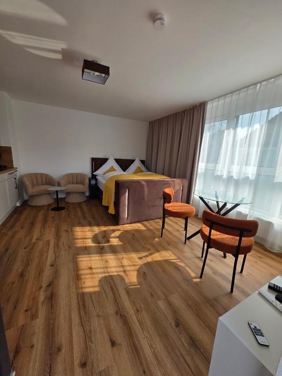a living room with a bed and a table and chairs at Cozy studio in Schwäbisch Hall in Schwäbisch Hall