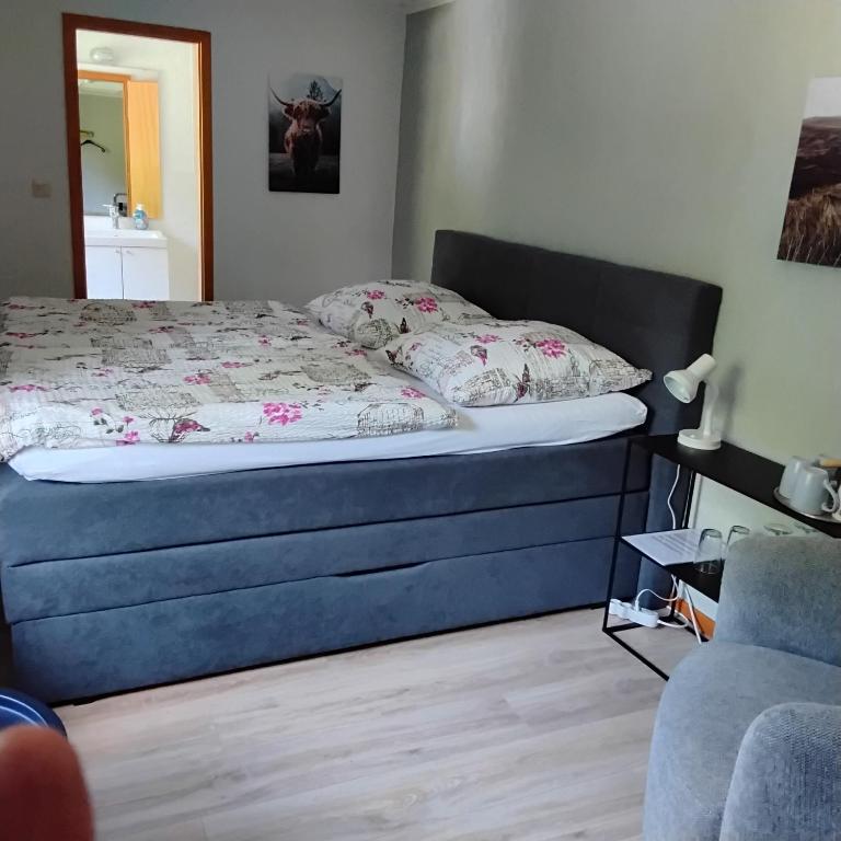 a bedroom with a bed with a blue frame at Hochwald EnSuite in Bad Sachsa