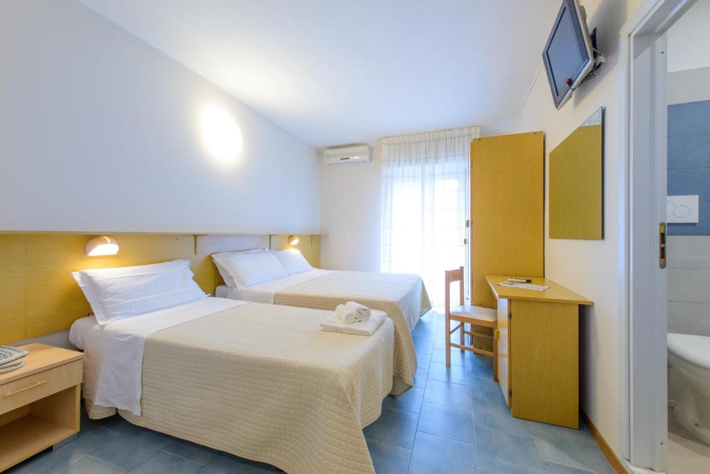 Postel nebo postele na pokoji v ubytování Hotel Falco