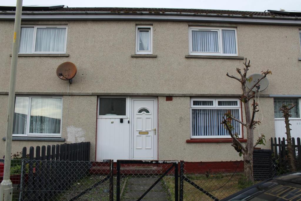 a house with a white door and a fence at wyvis stays in Inverness