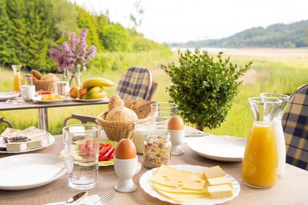 a table with food and eggs and cheese on it at B&B Gösselsdorfer Seeblick in Sittersdorf