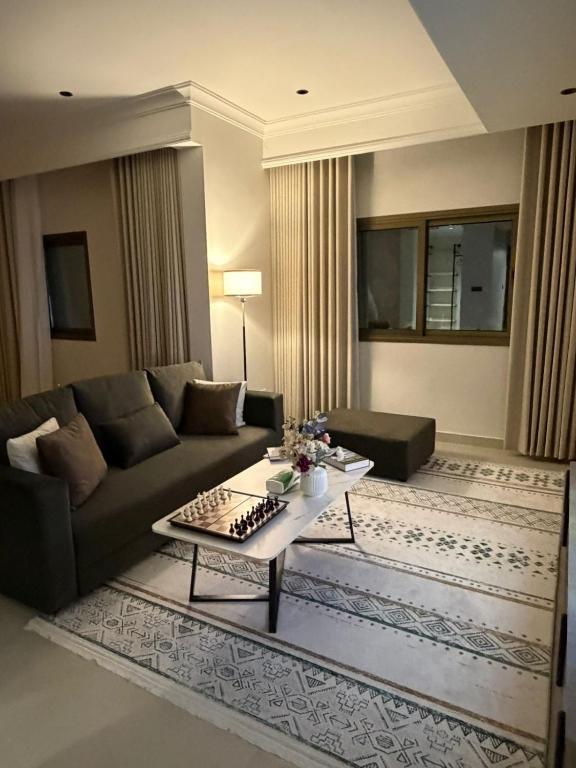 a living room with a couch and a coffee table at Studio in South Khobar in Al Khobar
