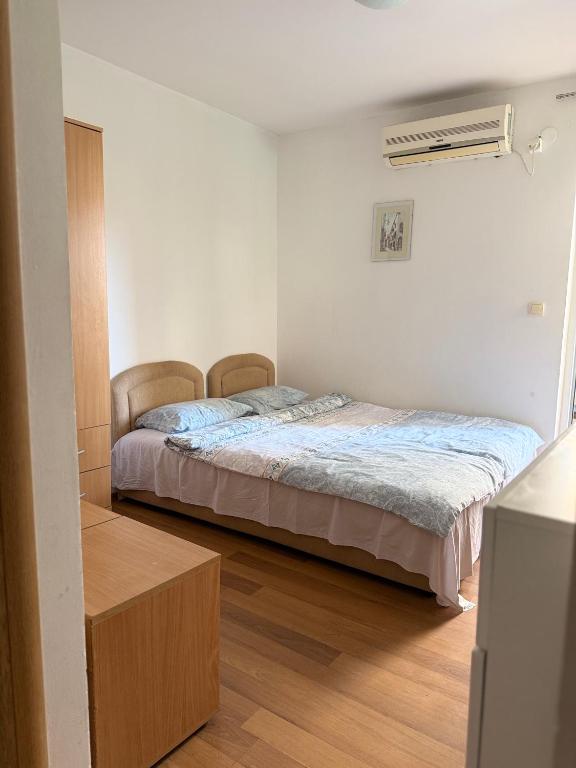 a bedroom with a bed in the corner of a room at Splendid corner in Bečići