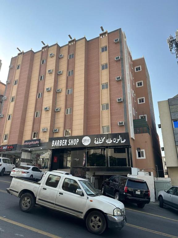 a white truck parked in front of a building at رحيانه ابها in Abha