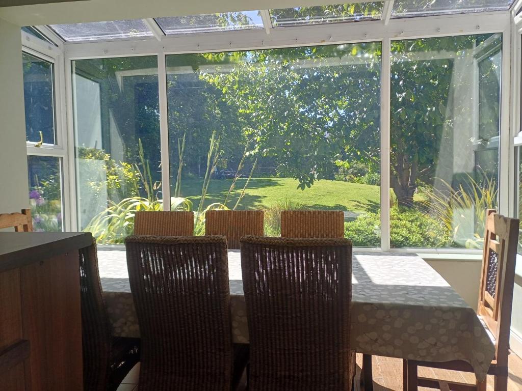 a dining room with a table and chairs and a window at Ethan House in Killarney