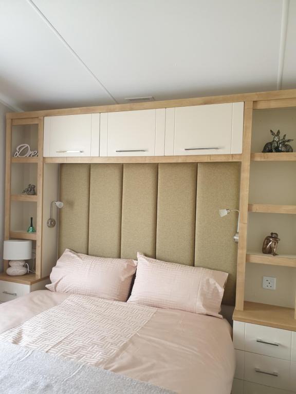 a bedroom with a large bed with white cabinets at K7 Annandale in Winthorpe
