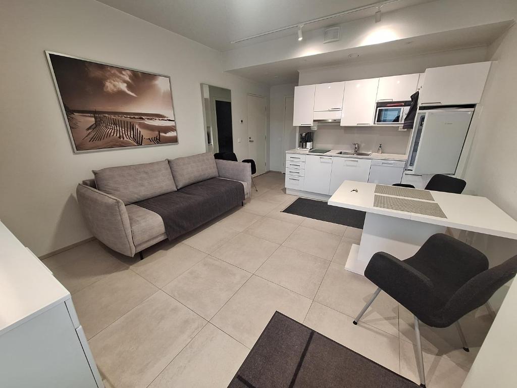 a living room with a couch and a table at Apartment Songhill in Kuopio