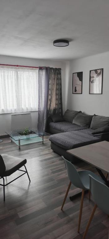 a living room with a couch and a table at Appart 1 bray dunes Minouche in Bray-Dunes