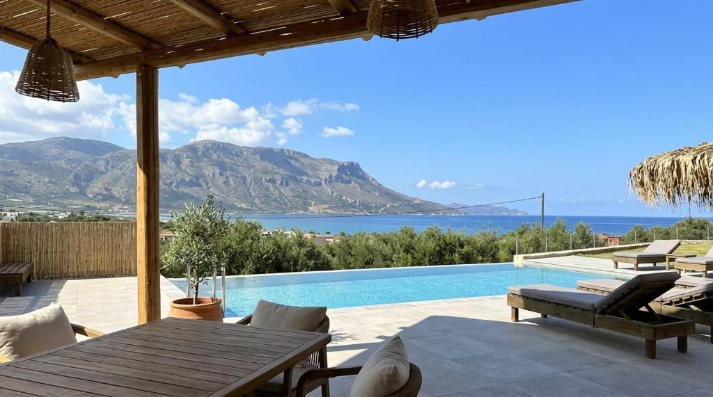 a villa with a pool and a view of the ocean at Nusa Retreat - Seaview luxury residences - ideal for groups in Kissamos