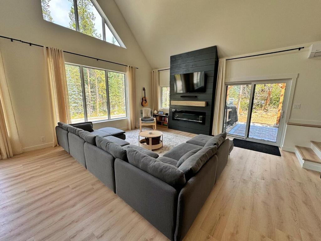 a large living room with a couch and a tv at Quiet detached home steps from all the action! in Panorama