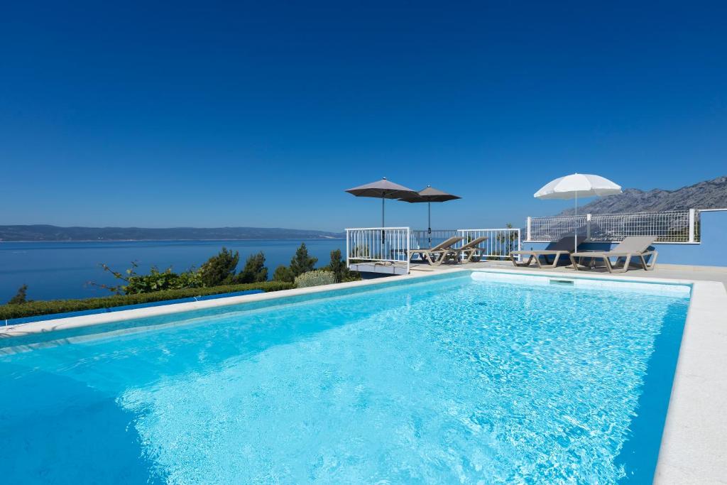 a swimming pool with a view of the water at Villa Vineyard oaza in Brela