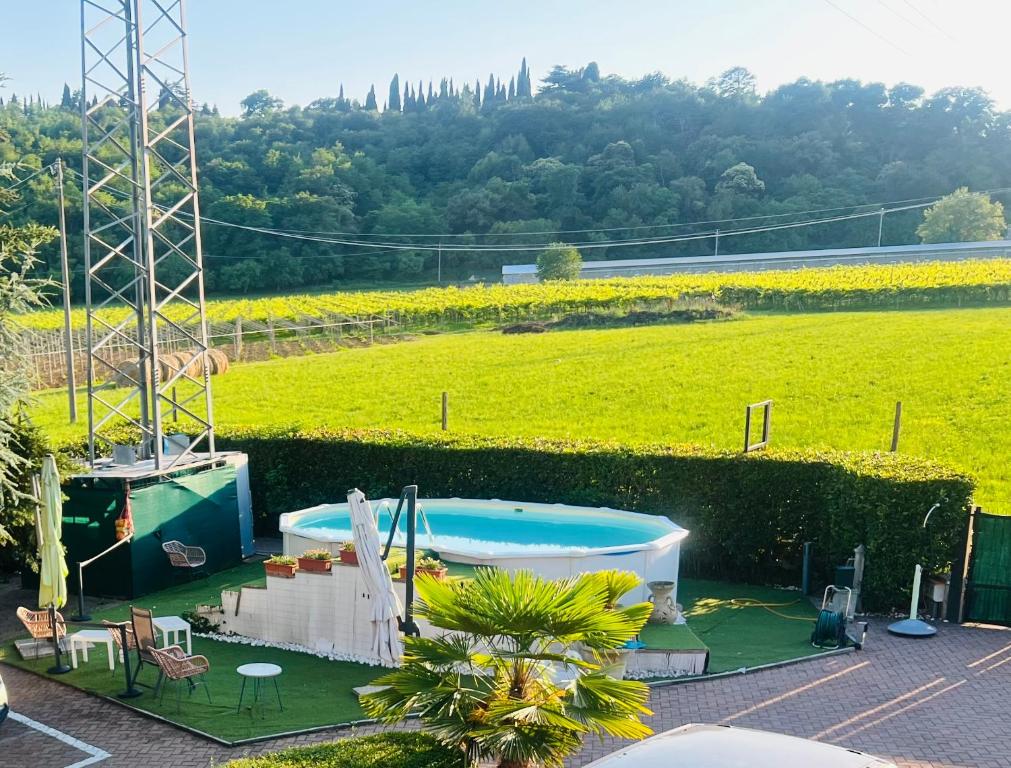 a view of a swimming pool and a field at La perla del Garda in Costermano