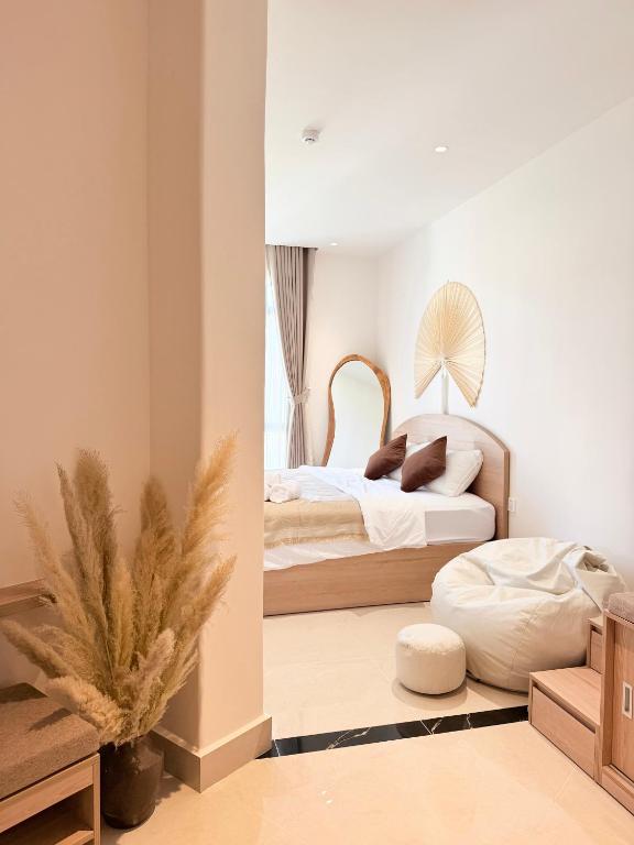 a bedroom with two beds and a window at Olivea Boutique Hotel Phu Quoc in Phú Quốc