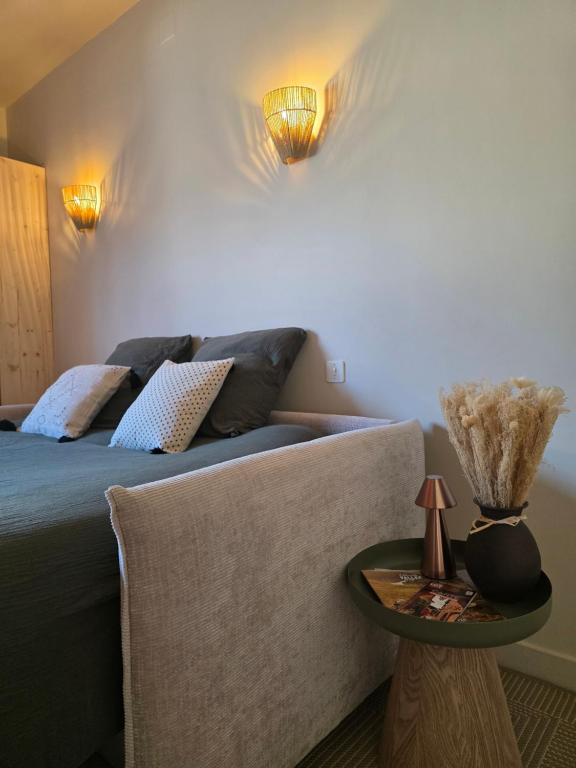 a bedroom with a bed and a table and lights at L'Empreinte in Cahors