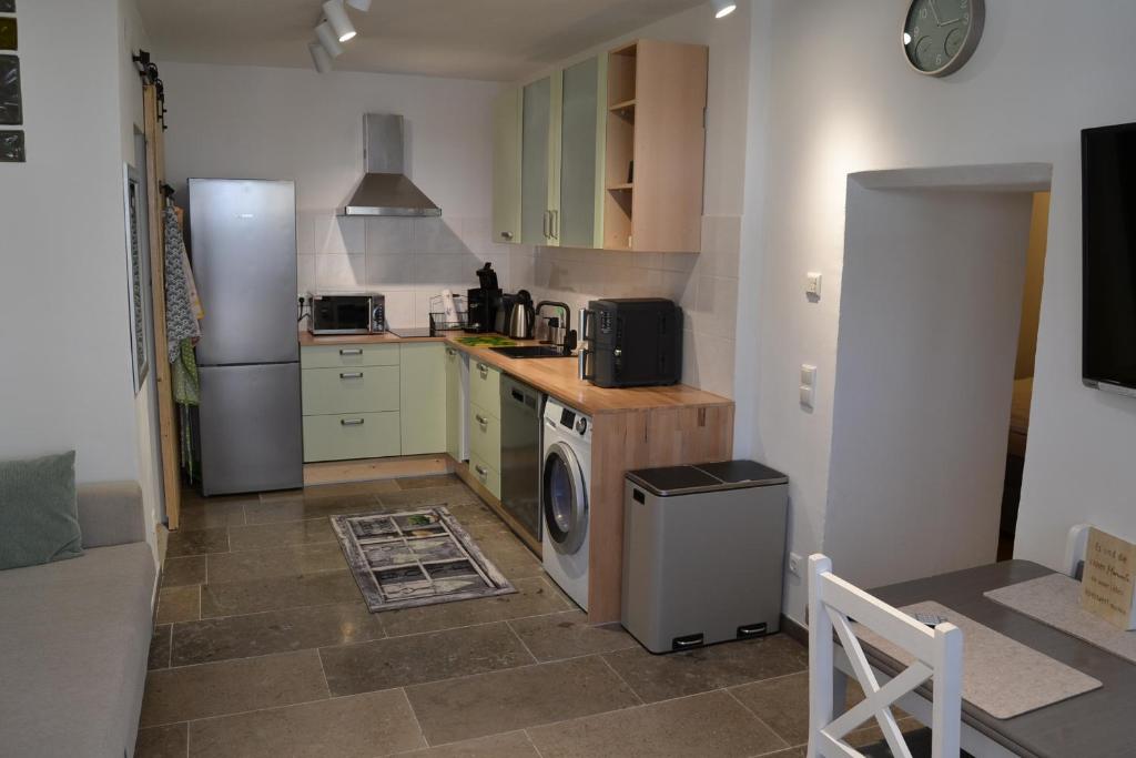 a kitchen with green cabinets and a refrigerator at Am Burg in Klotten