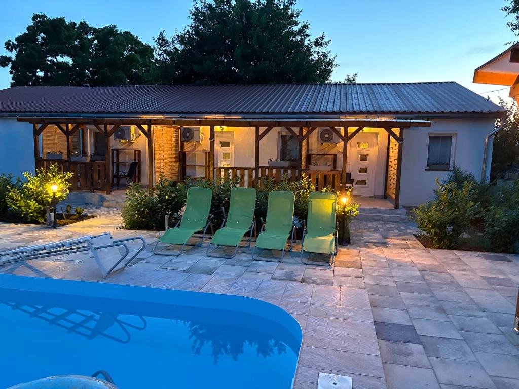 a patio with chairs and a swimming pool at Samu Tanya in Gyula