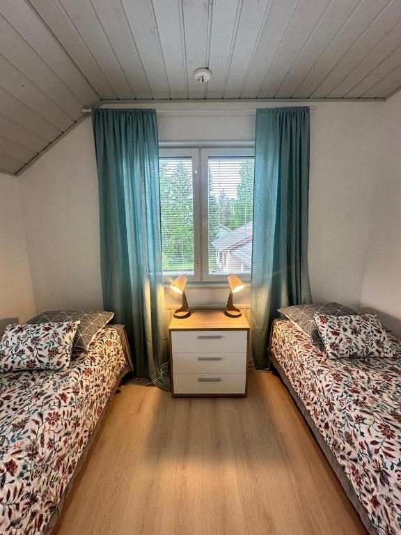ein Schlafzimmer mit zwei Betten und einem Fenster in der Unterkunft Airin in Imatra