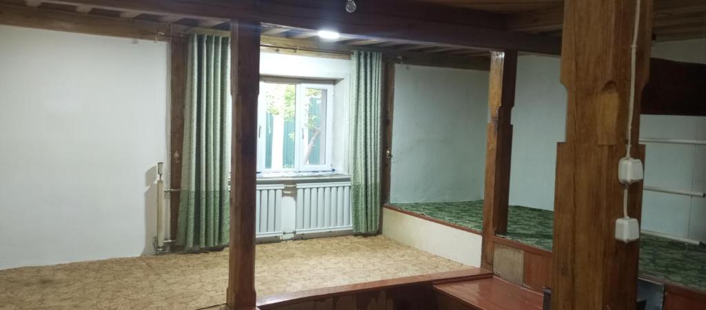 a mirror in a room with a window at Памирский дом in Khorog