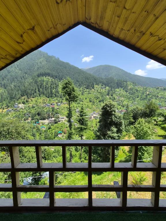a view from a window of a mountain at skytouch Lambri pass view Jibhi in Jibhi