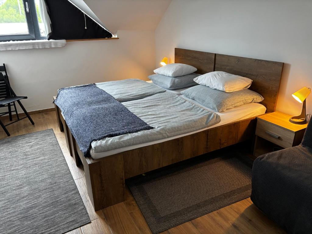 a bedroom with a large bed with two pillows at Megacentrum Szállás in Szekszárd