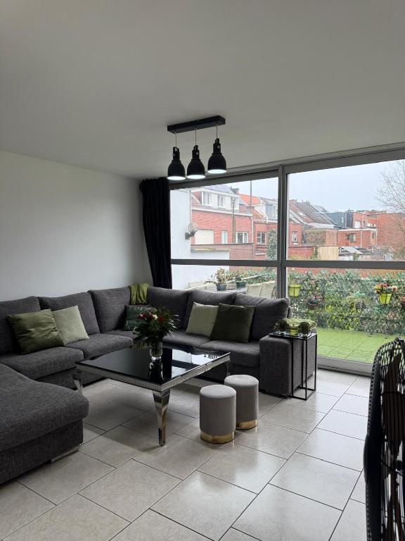 a living room with a couch and a table at Tomorrowland Home in Boom