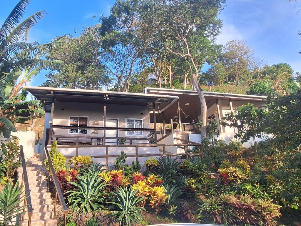 a house with a garden in front of it at Stone Hill farm & cabins in Penonomé