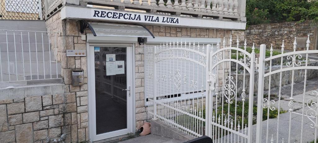 an entrance to a building with a white gate at Guest house Vila Luka 2 in Portorož