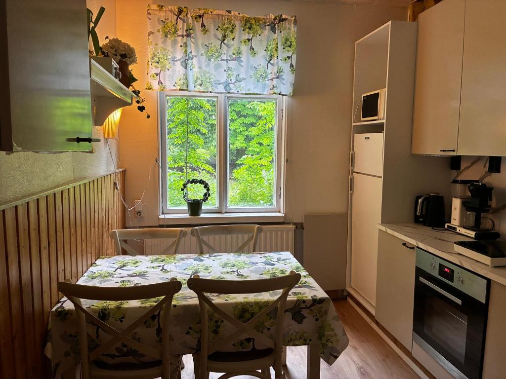 a kitchen with a table and chairs and a window at VILLA ANNA in Naantali