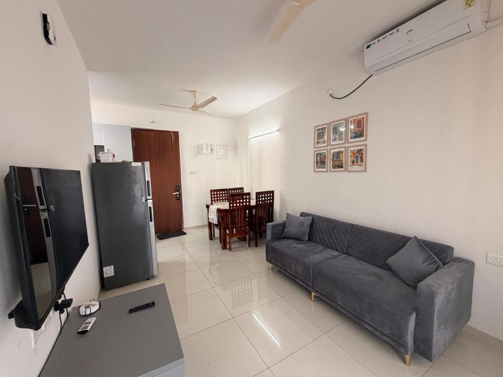 a living room with a couch and a table at Jula Hearth 1BHK in Chicalim