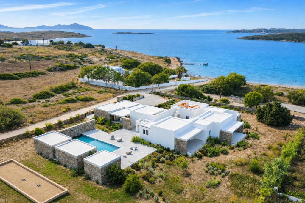 an aerial view of a white house with a pool at POP Villa - a family-friendly ambience by the sea in Santa Maria