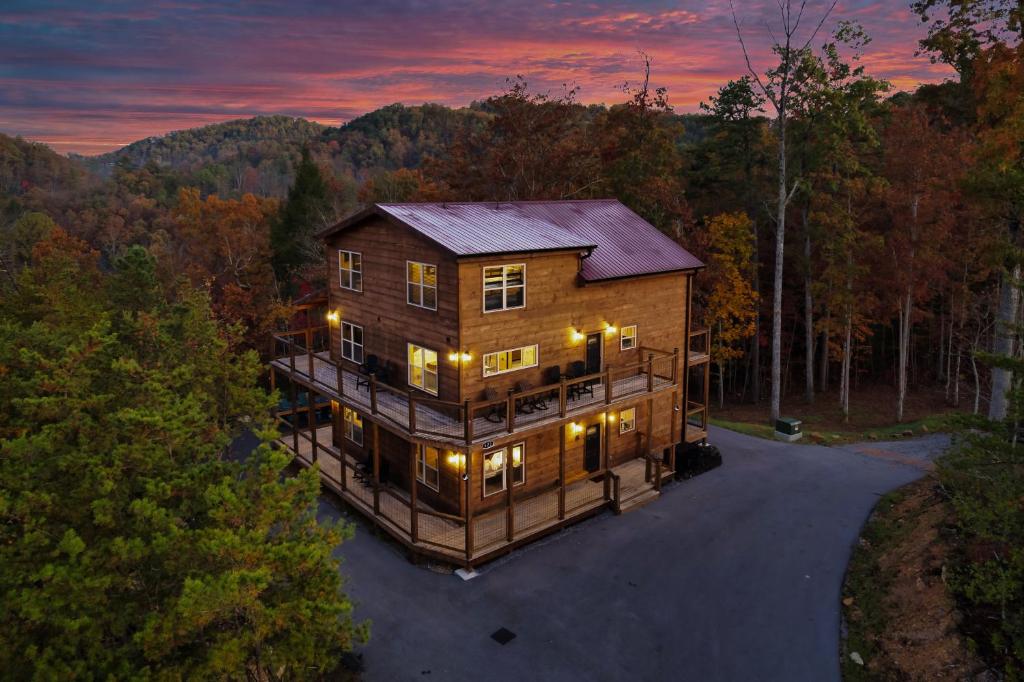 an overhead view of a large wooden house in the woods at Smoky Mountain Cabin, Sleeps 12, 2 Kitchens & Hot Tub in Pigeon Forge
