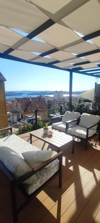 a patio with two chairs and a table on a roof at ELEVEN in Šibenik