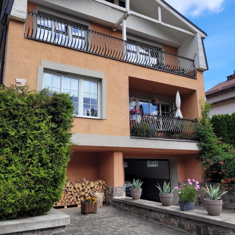 a house with a balcony with plants on it at Słoneczne piętro w Kolbudach in Kolbudy