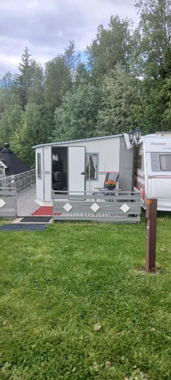 an rv is parked in a yard next to a field at Hagen Camping Mini hus in Kjerrvika