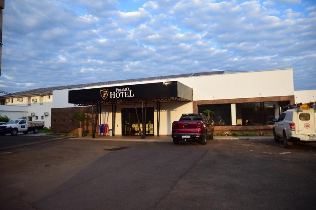a hotel with a red truck parked in front of it at Priamo Hotel in Santo Antonio do Sudoeste